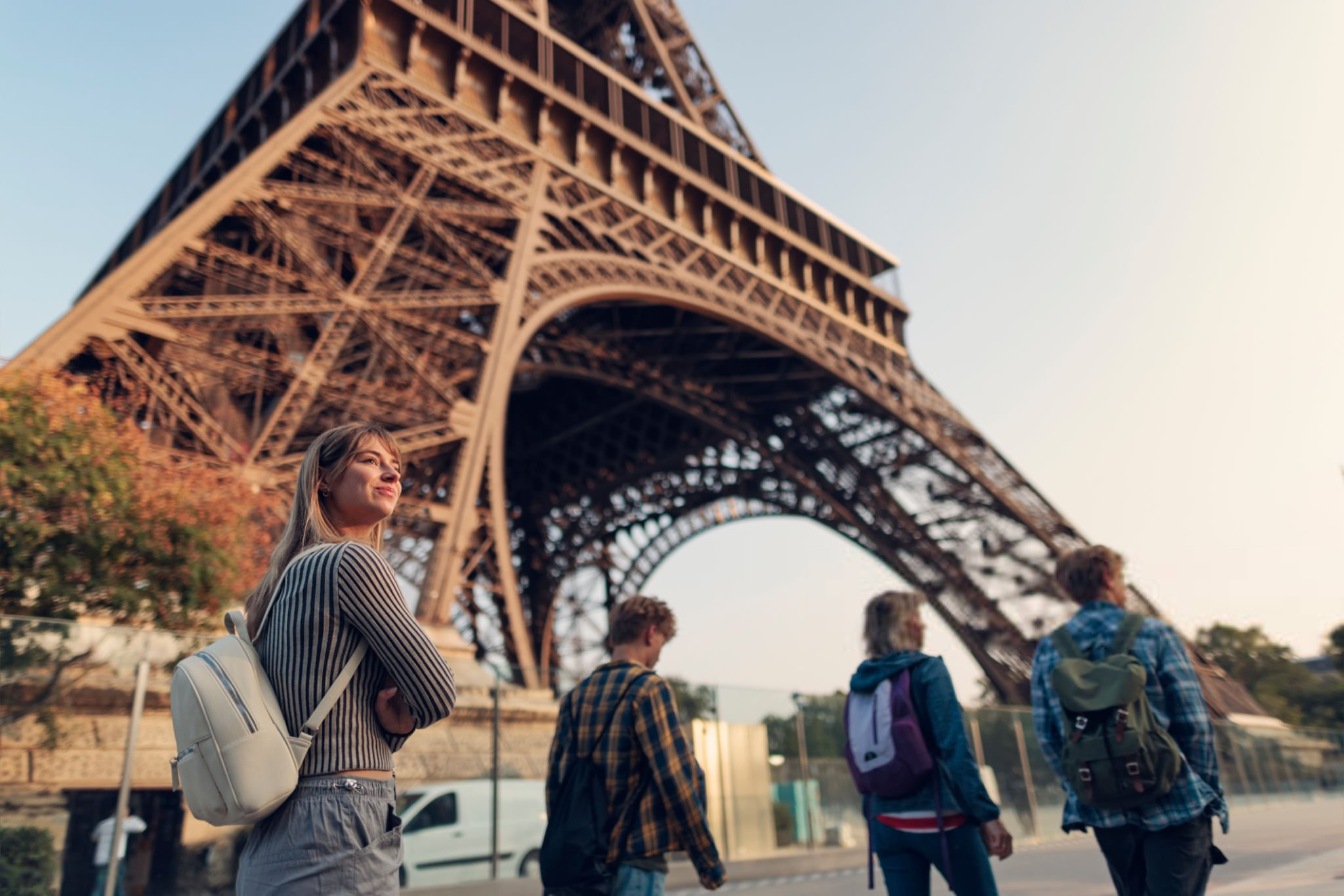 Happy tourist family walking near the base of the Eiffel Tow